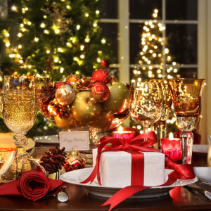 Festive table setting with red ribboned gift